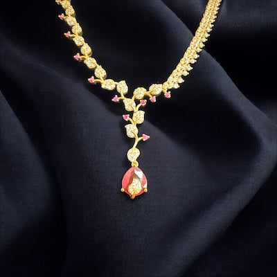 Glamorous AD Necklace Set in Gold Finish with Red Tear Drop