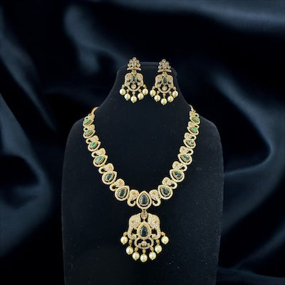 Chic AD Victorian Finish Necklace Set with Green Stones and Ganesha Motifs